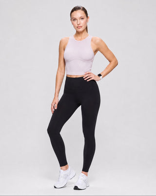Pale pink fitted ribbed crop tank top paired with black leggings and sneakers, a versatile women's athleisure look for workouts, yoga, running errands, travel, and casual everyday style.