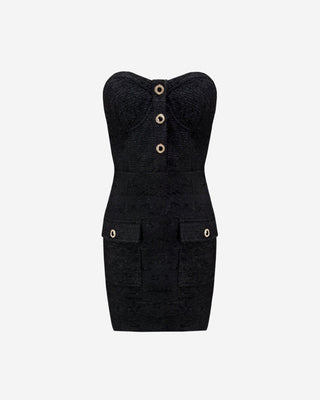 A black tweed mini dress with gold buttons and rhinestone embellishments, featuring a snug fit and hidden zipper at the back.