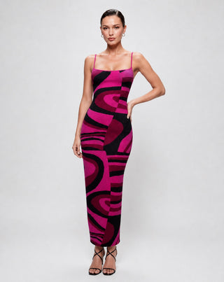 Women's abstract print bodycon maxi dress in vibrant pink and black featuring spaghetti straps, a square neckline, and a figure-hugging silhouette