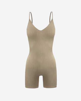Front view of a neutral women’s ribbed romper highlighting slim straps, V-neckline, contoured fit, stretch knit fabric, and mid-thigh cut.