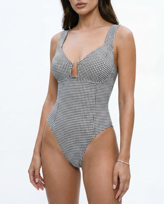 Women’s houndstooth print bodysuit with keyhole neckline, fitted silhouette, wide straps, and structured bust detail in black and white