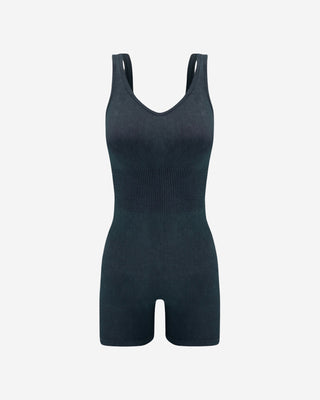 Black seamless ribbed tank romper with scoop V-neckline, wide straps, contoured waist and fitted biker shorts, a versatile women’s one-piece for athleisure, travel, lounging and everyday wear.