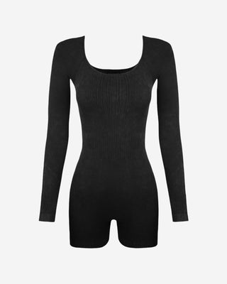 Front view of a black women’s ribbed romper highlighting long sleeves, scoop neckline, contoured fit, and stretch knit construction.