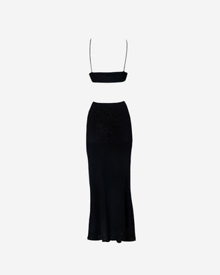 Back view of a black maxi dress for women showing a streamlined fit, minimal back design, thin straps, and full-length skirt.