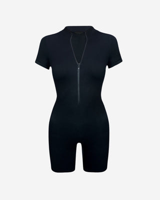 Black short sleeve zip front romper with fitted silhouette, biker shorts and mock neckline, a versatile women’s one-piece for athleisure, travel, casual outings and everyday streetwear.