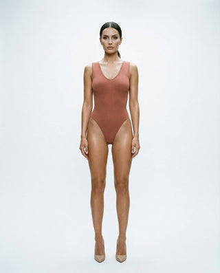 Ribbed sleeveless bodysuit for women featuring a scoop neckline, high-cut leg openings, and a smooth body-contouring fit, styled on a model against a white studio background.