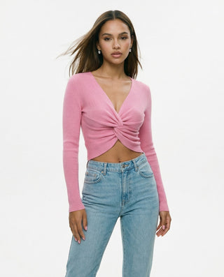 Women’s pink long sleeve twist front crop top with V-neckline, styled with light wash jeans for a feminine casual chic, brunch, date night, and everyday outfit