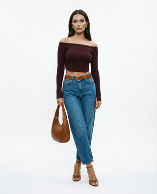 Model wearing maroon colored long sleeve boatneck top with blue jeans and brown accessories.