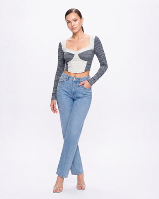 Women’s blue and white long sleeve fitted crop top with contrast colorblock design, paired with light wash jeans and heels for a chic going-out, weekend, and casual street style look