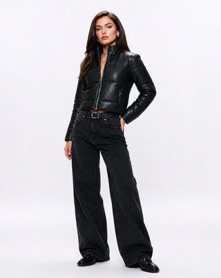 Women's cropped black faux leather puffer jacket with a zip-front closure, stand collar, and modern quilted silhouette