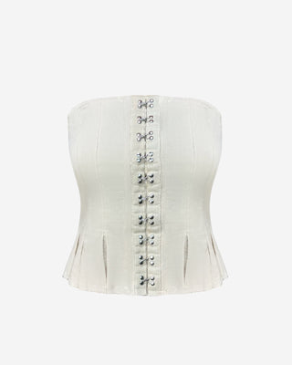 White corset tube top for women featuring front hook-and-eye closures, sculpting seams, peplum detail, and a chic strapless silhouette for day-to-night styling