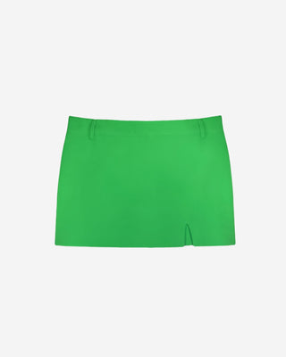 Emerald green high rise mini skirt with a smooth tailored finish, belt loops and a clean straight hemline with a small side slit shown from the front on a white background.