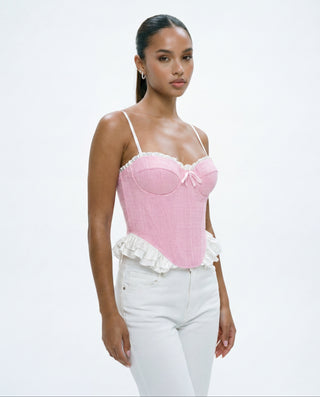 Pink structured bustier top with contrast white ruffles, thin straps and corset-inspired fit, styled for spring outfits, brunch, vacation, parties and romantic weekend looks.