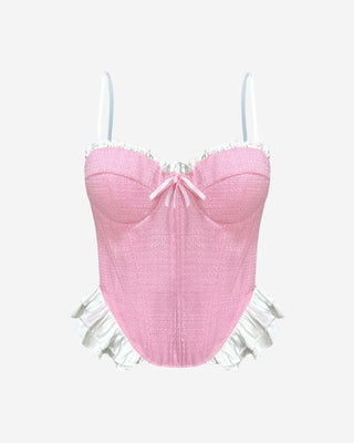 Pink tweed corset bustier top with sweetheart neckline, white ruffle trim, bow detail and pointed hem, a feminine statement top for date night, brunch, parties and spring-to-summer outfits.