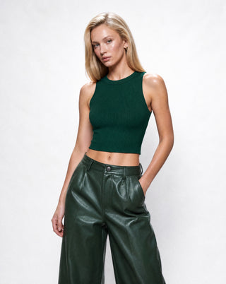 Women's forest green ribbed crop tank top with a high neckline and slim fit, paired with green faux leather trousers for a chic monochromatic fashion look