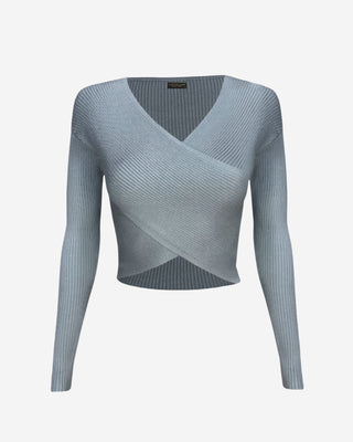 Front product shot of a soft blue ribbed knit cropped top featuring a crossover wrap design, long fitted sleeves, and a flattering V-neck silhouette.