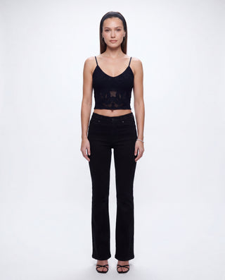 Women's black lace camisole crop top with delicate sheer lace accents and slim spaghetti straps paired with black denim