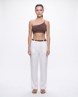 Women’s brown ribbed one shoulder crop top styled with white wide leg pants and sandals for chic summer outfits, vacation wear and elevated casual style.