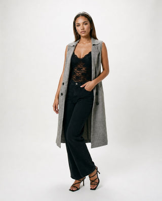 Women’s gray longline sleeveless duster vest styled with black lace bodysuit and wide leg jeans for sophisticated dinner outfits, girls’ night and modern street style.