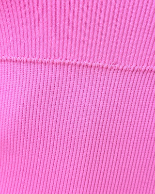 Close-up detail of a pink fitted romper for women showing smooth stretch knit fabric, soft texture, and seamless construction.
