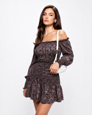 Women's black floral off-the-shoulder smocked mini dress with long puff sleeves, styled with a white shoulder bag for a chic fall brunch, date night, or weekend outfit.