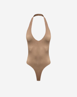 A tan halter bodysuit with a V-neckline and thong fit design.