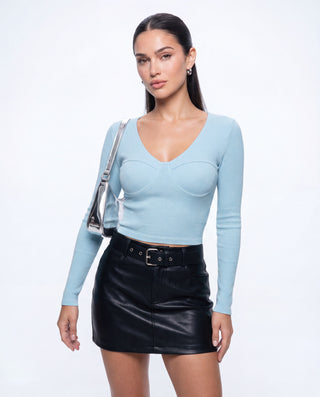Women’s light blue ribbed bustier crop top with long sleeves and sculpted underwire detail, styled with a black mini skirt for date night, girls’ night and going-out outfits.
