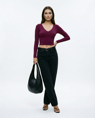 Burgundy long-sleeve bustier crop top for women featuring a V-neckline, fitted silhouette, ribbed fabric, and modern sculpted design on a white background.