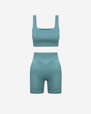 Seamless set in seafoam green color, including a matching tank top and shorts designed for athletic activities.