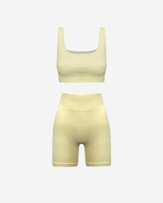 Butter yellow two-piece activewear set featuring a supportive square neck crop top and sculpting high-waisted biker shorts
