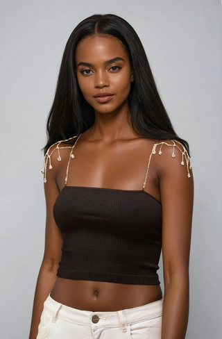Model wearing black tube top with crystal chain straps styled with off white jeans.