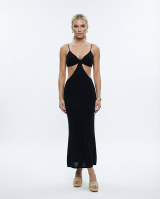 Black cutout maxi dress for women featuring thin straps, a V-neckline, front waist cutouts, and a sleek body-hugging silhouette, styled on a model against a white studio background.