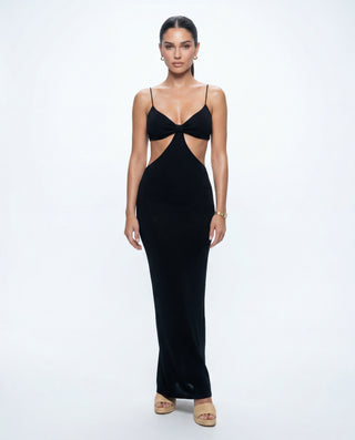 Black cutout maxi dress for women featuring thin straps, a V-neckline, front waist cutouts, and a sleek body-hugging silhouette, styled on a model against a white studio background.