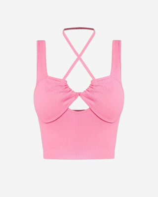 Pink ribbed crop top for women featuring a crossover halter neckline, front cutout detail, structured bust seams, and a fitted silhouette perfect for spring and summer outfits