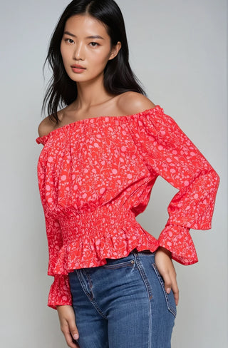 Red and pink chiffon smocked crop top paired with blue jeans.