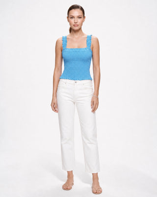 Women’s blue smocked fitted tank top with ruffle straps and square neck, paired with white denim for warm weather, resort wear, weekend outings and elevated casual style.