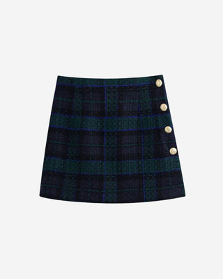 Plaid tweed high waisted mini skirt in deep navy and green tones with structured tailoring and gold button accents along the side seam, shown from the front on a white background.
