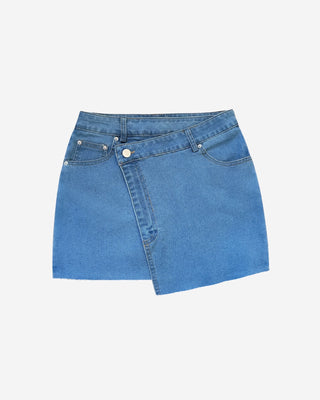 Front view of a women’s denim mini skirt highlighting the asymmetrical wrap silhouette, raw hem edge, and classic denim construction.