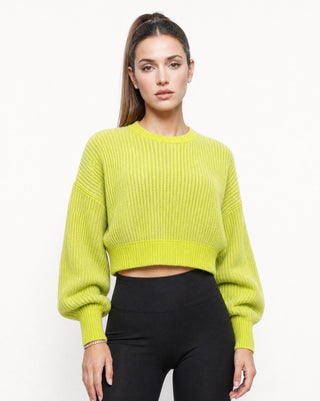 Women’s chartreuse green ribbed cropped sweater with crew neckline, relaxed drop shoulders and long balloon sleeves, styled with black leggings for a cozy fall outfit, casual weekend look and elevated everyday wear.