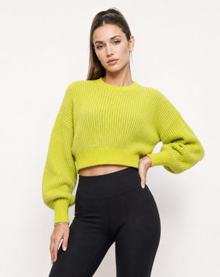 Women’s chartreuse green cropped knit sweater with oversized balloon sleeves and ribbed detailing, paired with high-waisted black leggings for a chic fall outfit, brunch look, travel style and casual streetwear.