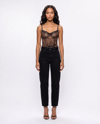 Women’s leopard print lace corset top styled with black high-waisted jeans and strappy heels, a chic animal print outfit for dinner dates, nightlife, parties and weekend plans.